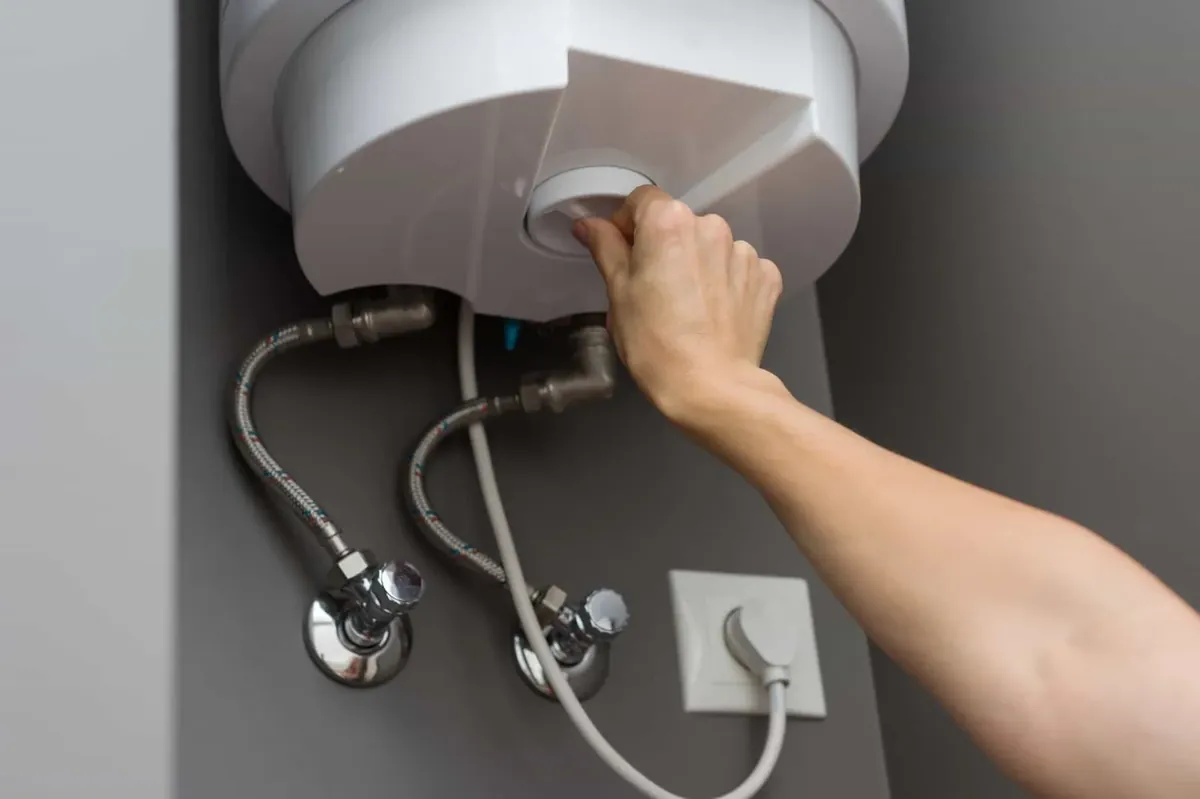 Smart Home Air and Heat technician servicing water heater in Orlando FL