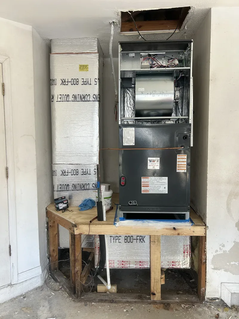 HVAC technician servicing a furnace heating system in East Orlando home